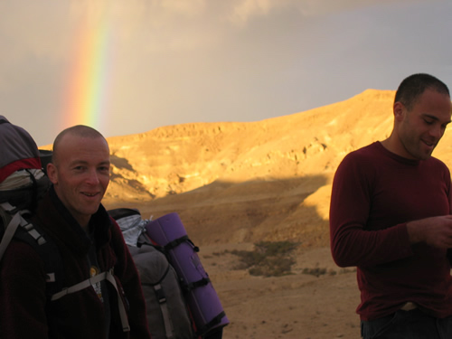 smiling faces with desert rainbow